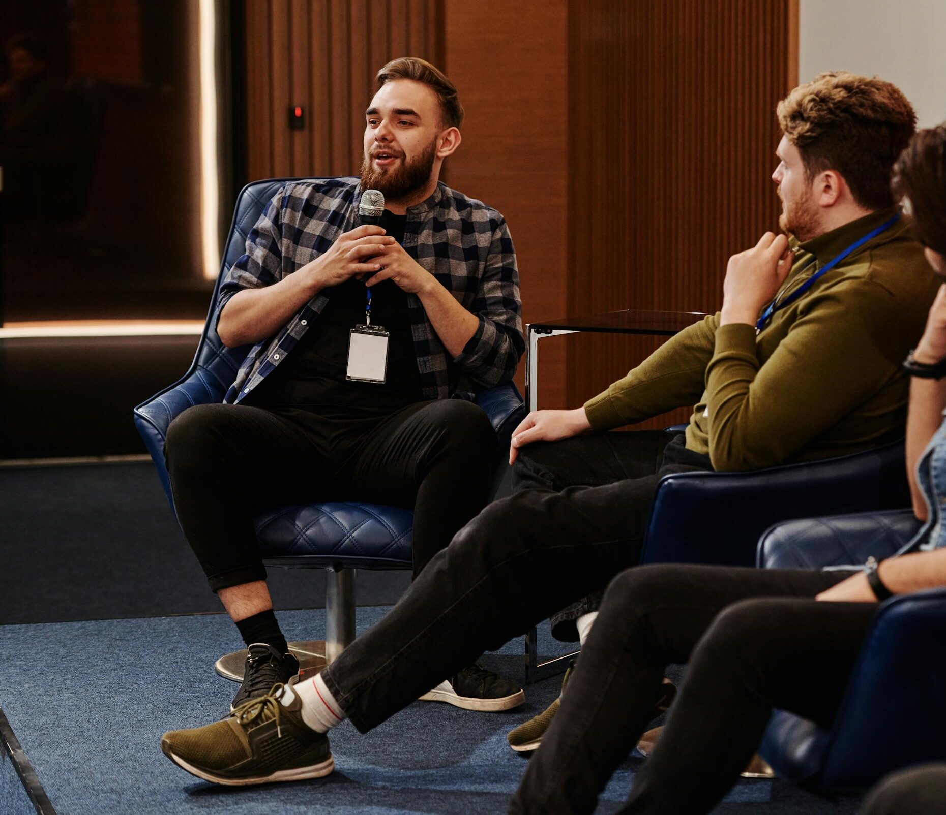 Group of young adults engaging in a lively panel discussion, fostering collaboration.